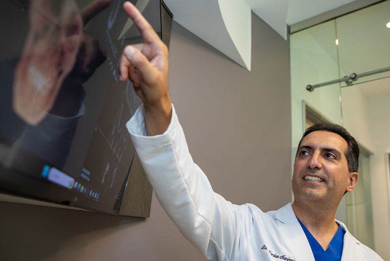doctor going over dental procedure information within the dental center