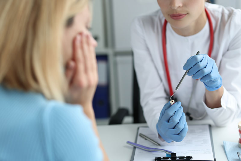 Dental member showing dental patient with tooth pain causing issue