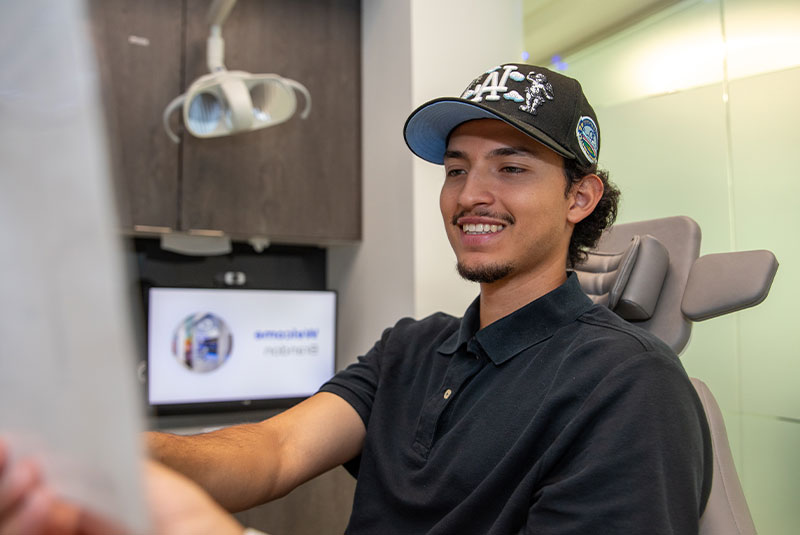 patient smiling brightly after their dental treatment within the dental center