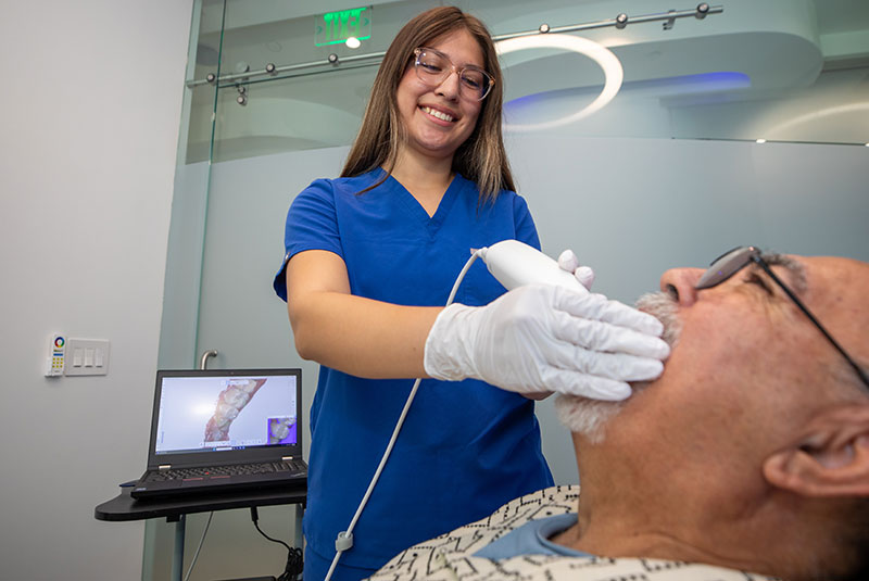 staff member helping patient with treatment examination