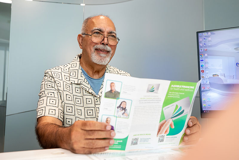 dental patient looking over dental finance options during their consultation