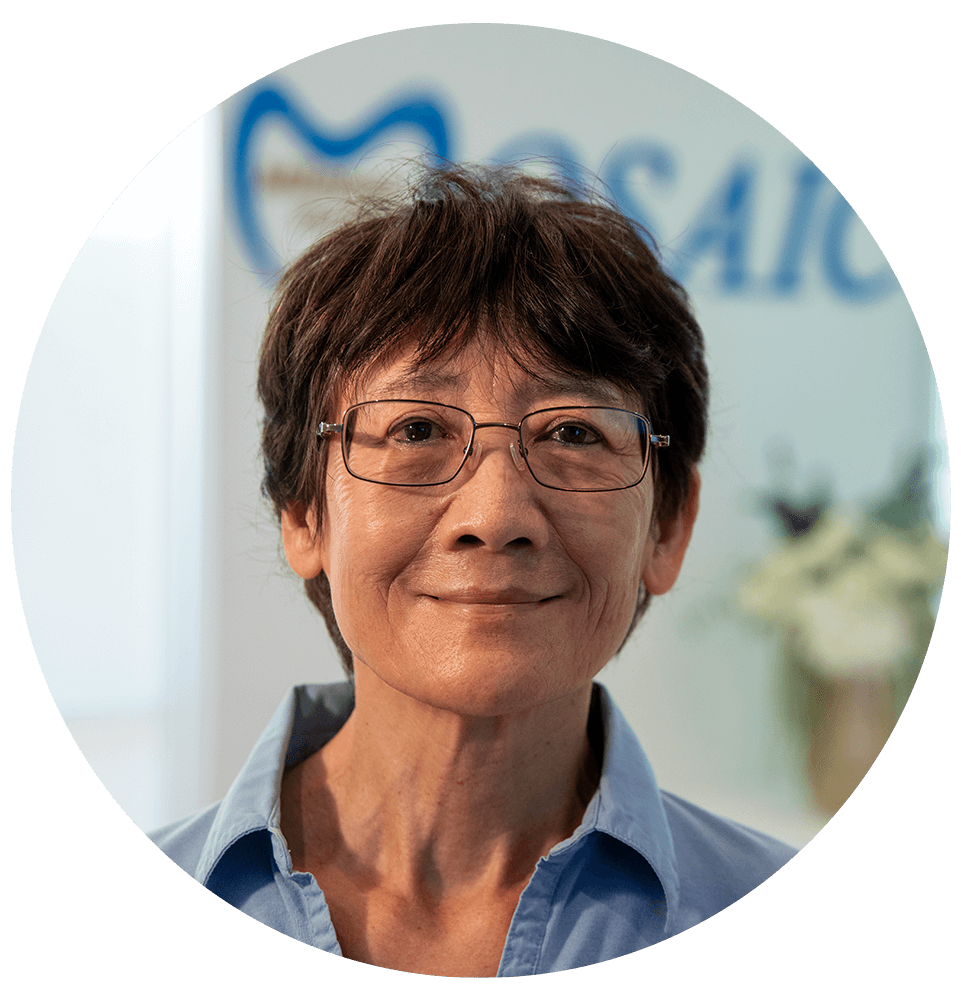headshot of patient smiling brightly after their dental procedure