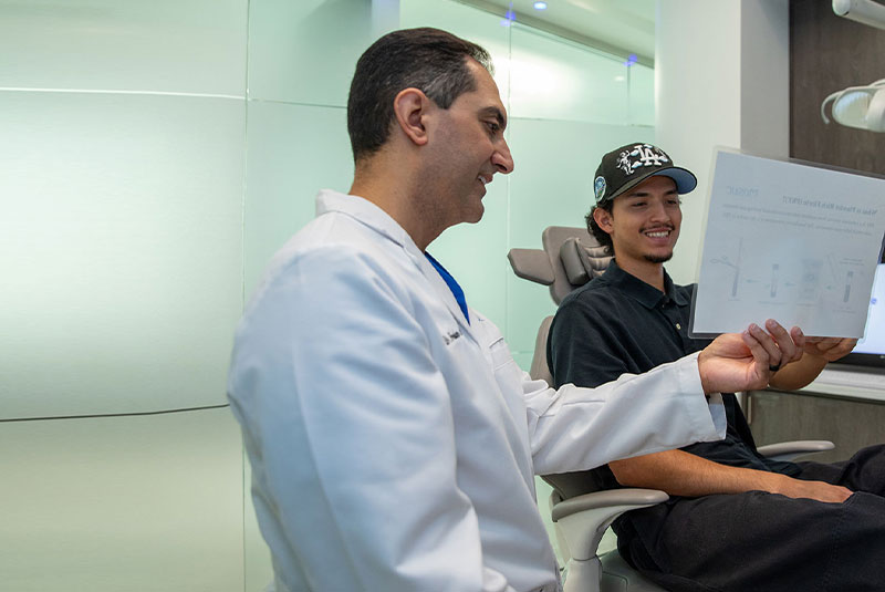 doctor going over dental procedure information with patient